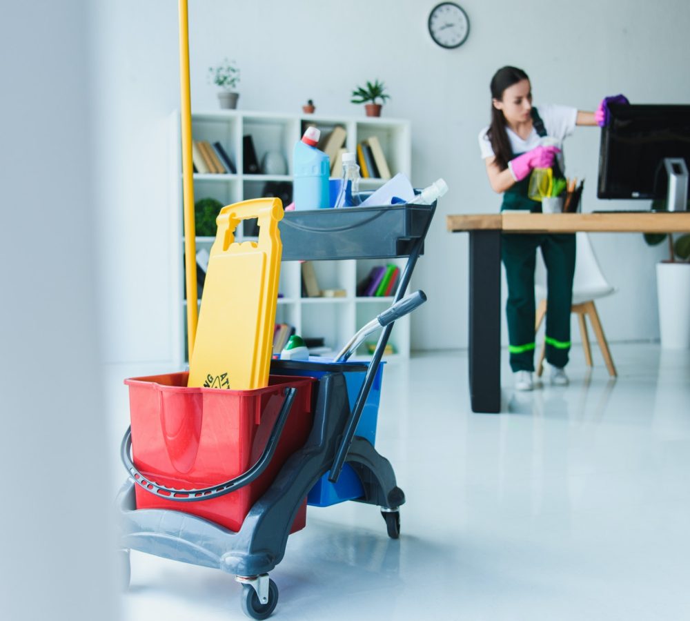 young-female-janitor-cleaning-office-with-various-cleaning-equipment.jpg young-female-janitor-cleaning-office-with-various-cleaning-equipment.jpg